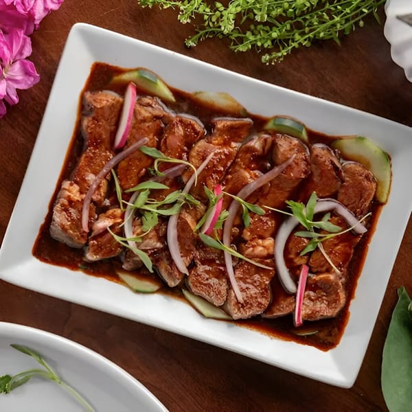 Mezcal Mexican Restaurant's carne asada, garnished with red onions, radishes, and cilantro.