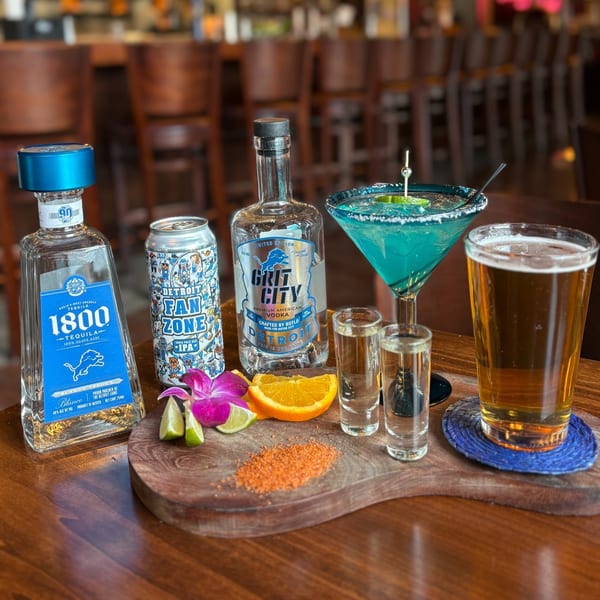 Mezcal Mexican Restaurant's display of tequila, vodka, beer, and a blue margarita with garnishes.